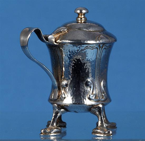 An Edwardian Arts and Crafts Cymric silver mustard pot, designed by Archibald Knox, for Liberty & Co, numbered 409, height 70mm,